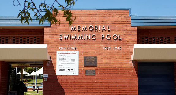 Carnegie Memorial Pool's red brick facade showing memorial plaques