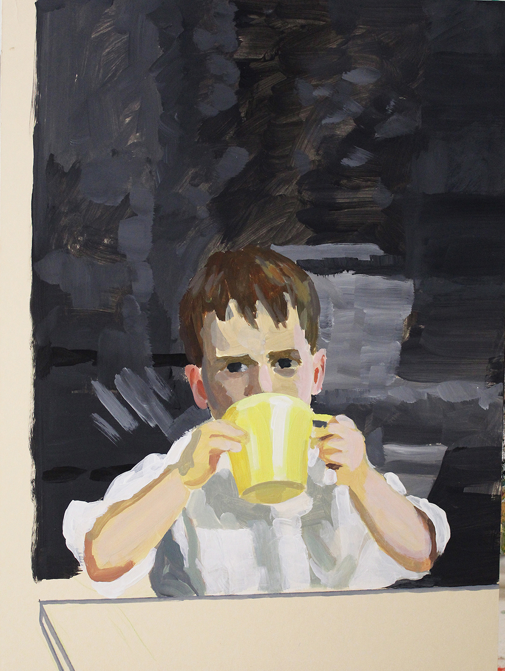 Child drinking from a yellow cup
