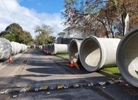 Sections of concrete drainage pipe flank Kalimna Street in preparation for installation at King George VI Memorial Reserve car park.