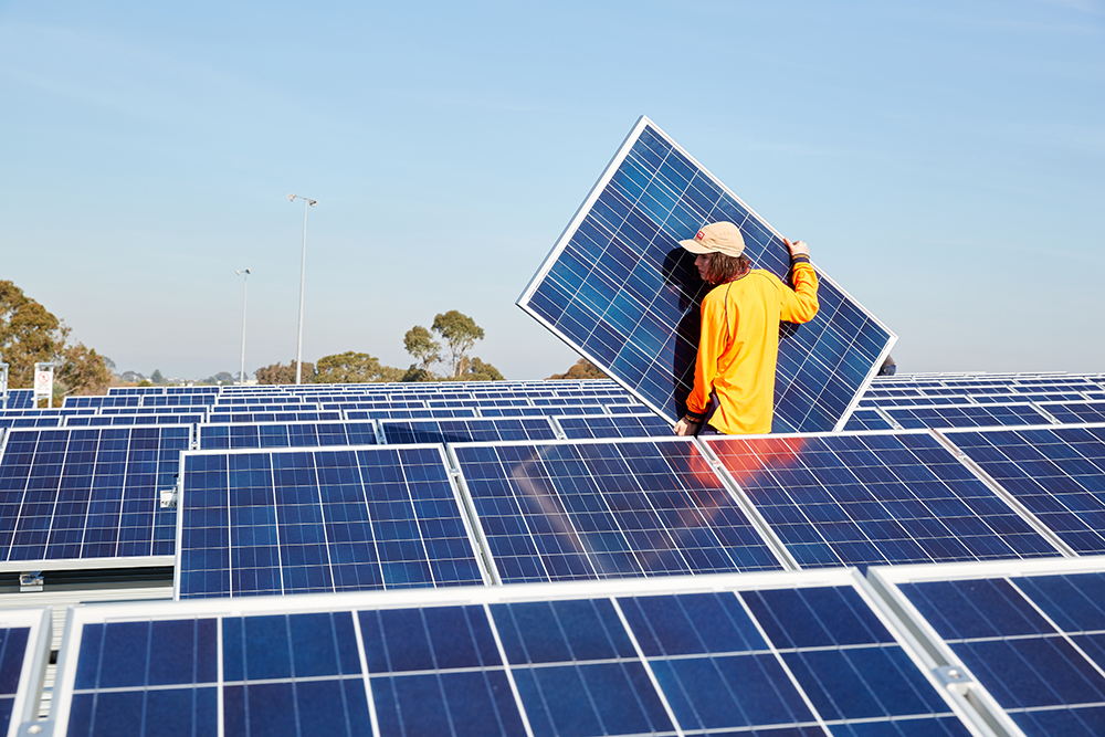 Person installing solar panels on GESAC