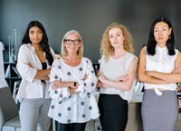 Four women standing with confident poses