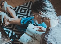 Lady reading a book while drinking coffee