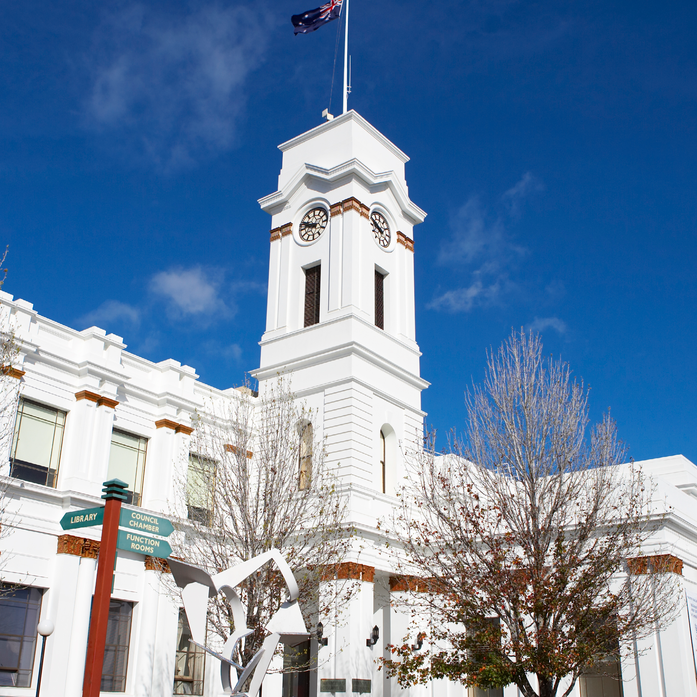 Town Hall clock and flag on building