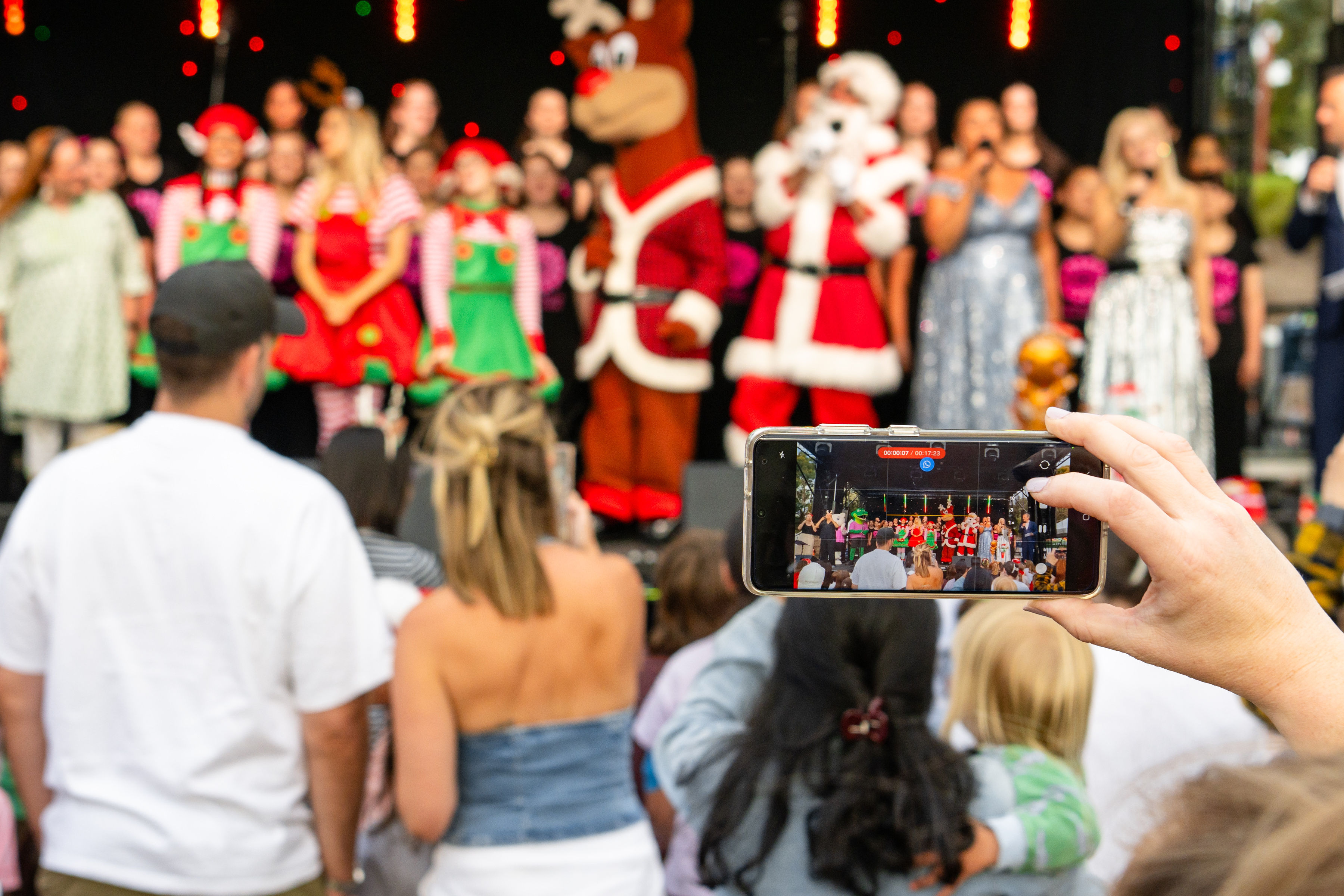 Someone using a smart phone to take a photo of a Christmas show