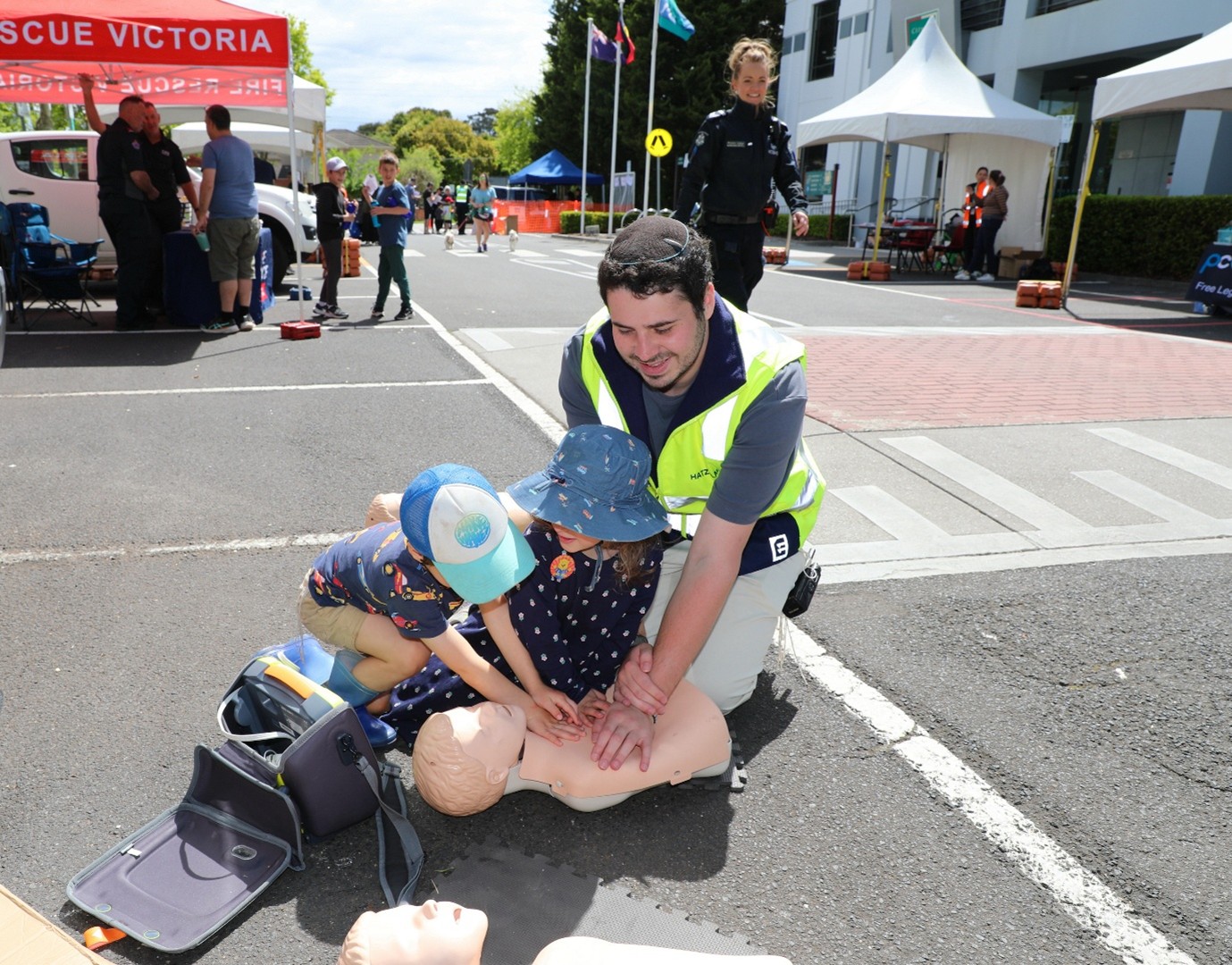 Man and child practicing CPR on a dummy
