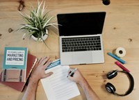 Laptop surrounded by office paraphernalia