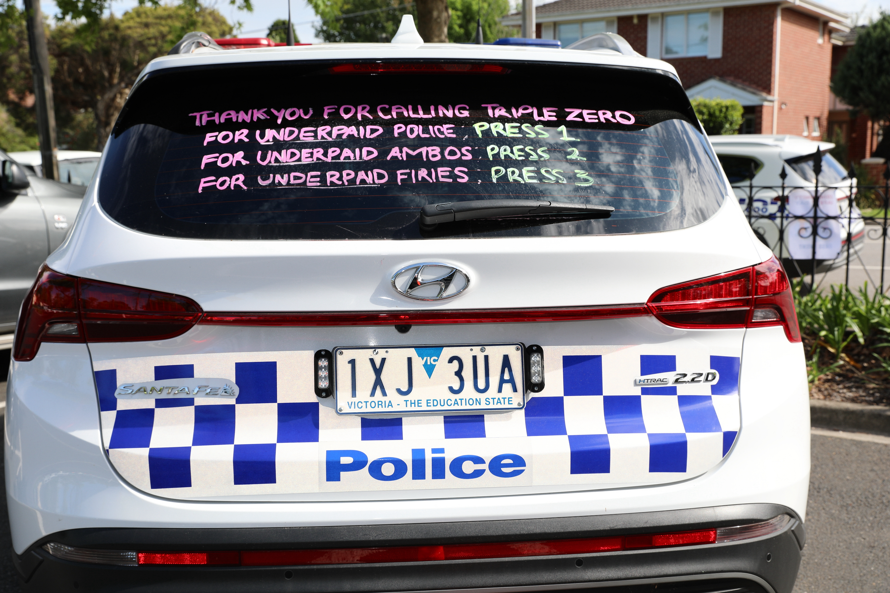 A creative display on a police vehicle at Community Safety Day highlighted calls from emergency service workers for fair pay and recognition of the essential services they provide to the Victorian community.