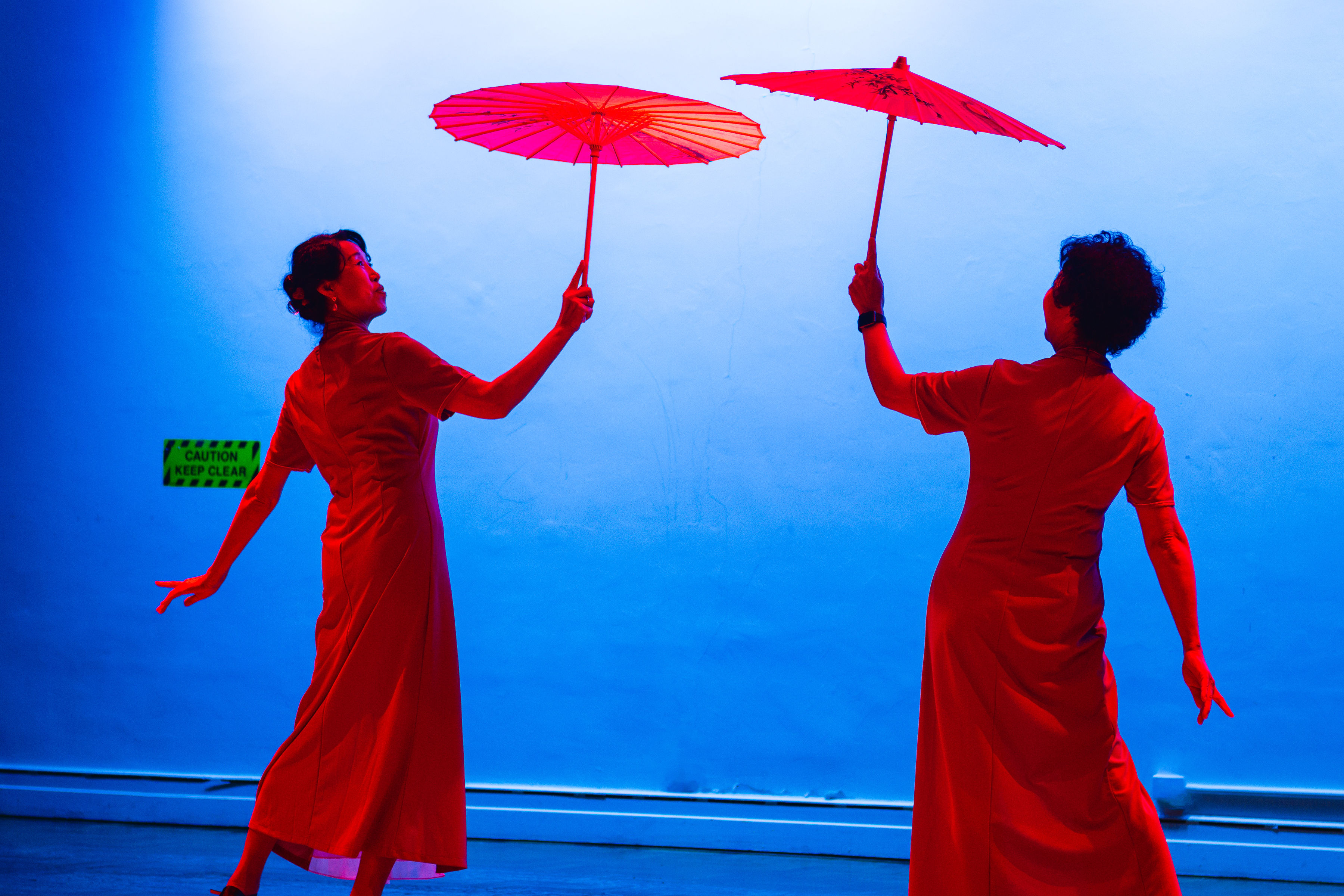 Women in red holding red parasols