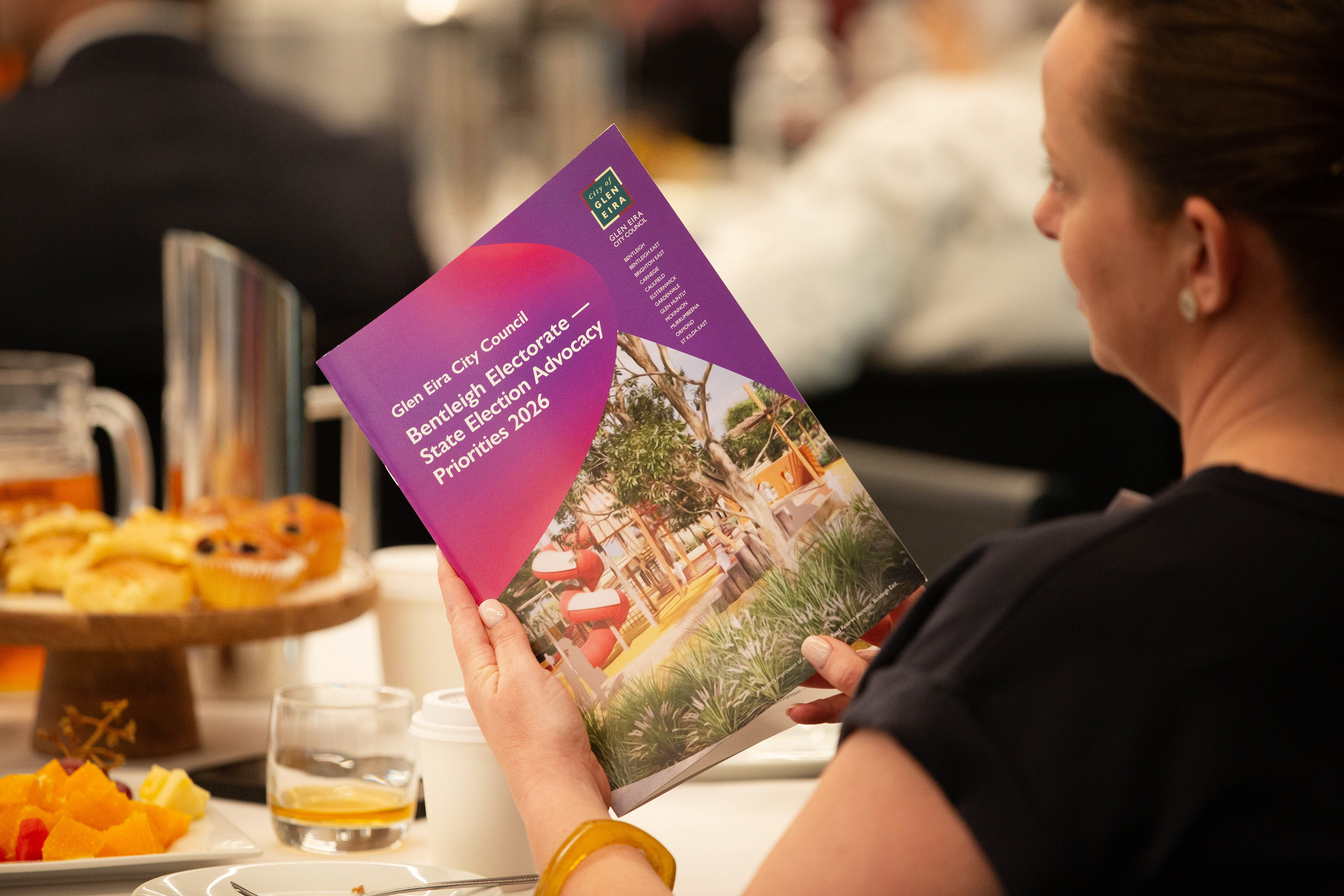 Attendee reads Glen Eira City Council’s Bentleigh Electoral State Election Advocacy Priorities 2026 booklet during an event.