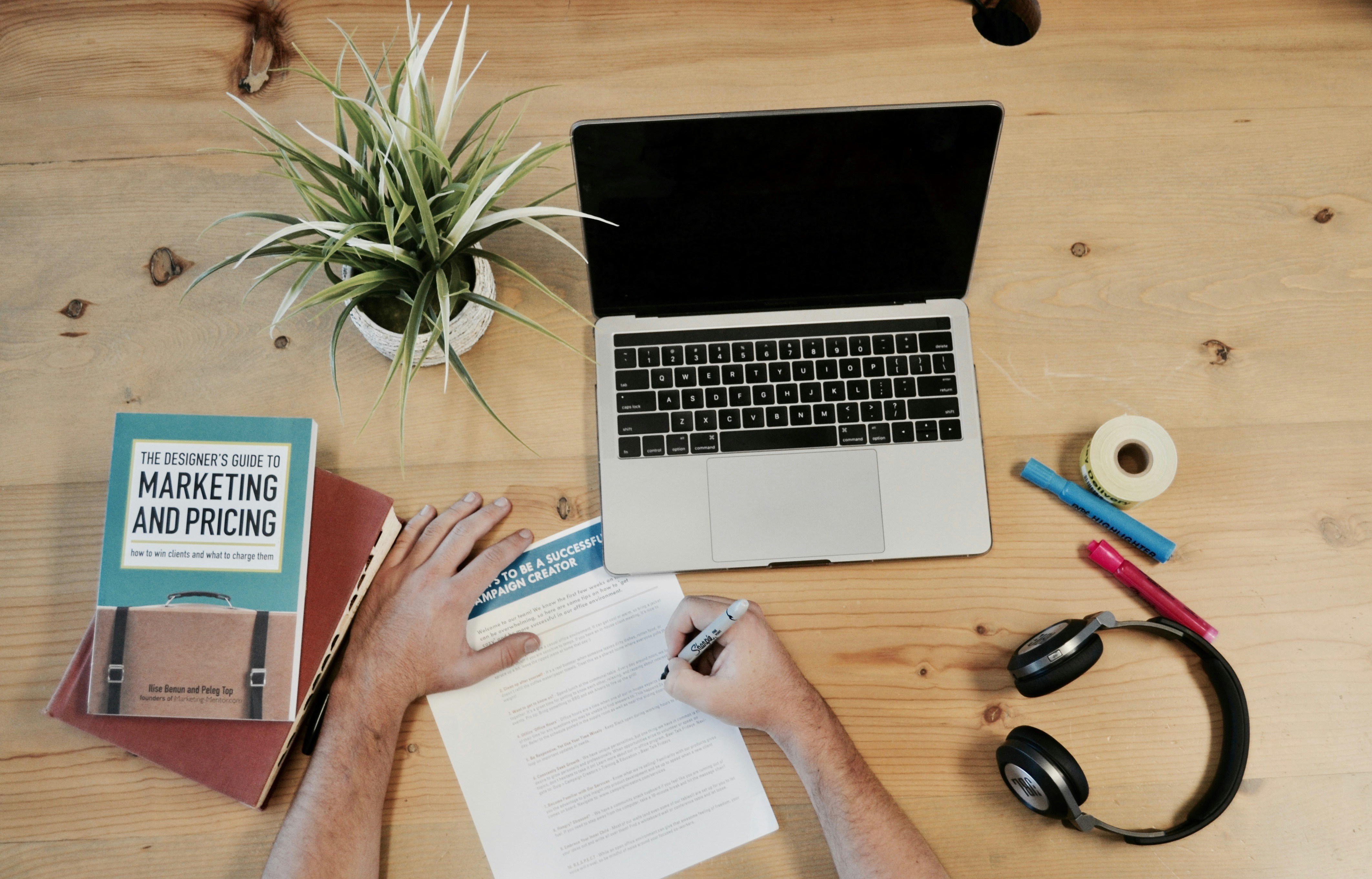 Laptop surrounded by office paraphernalia