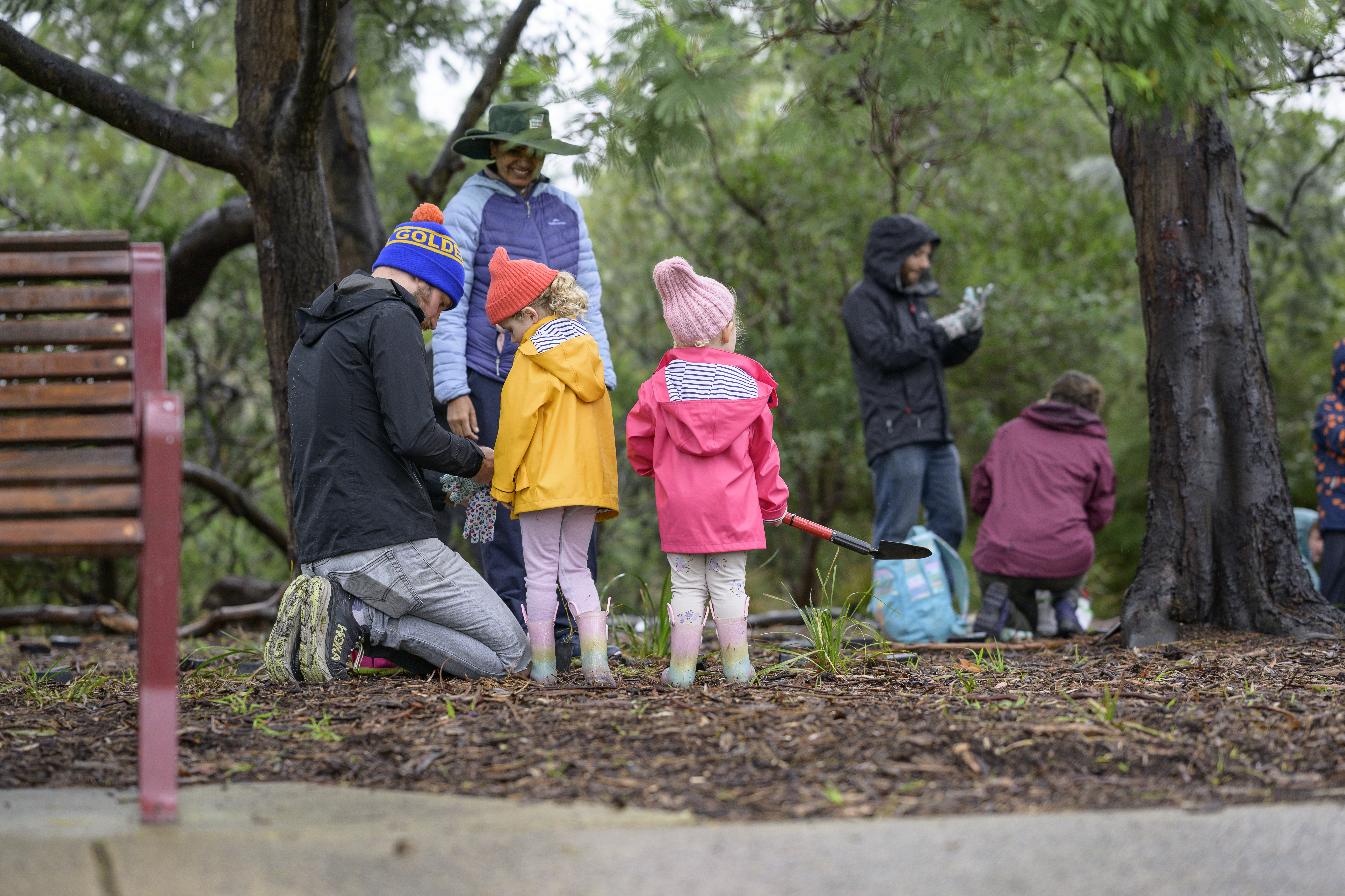 Group of girls and a parent planting plants