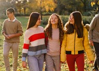 Group of teenagers walking through a park