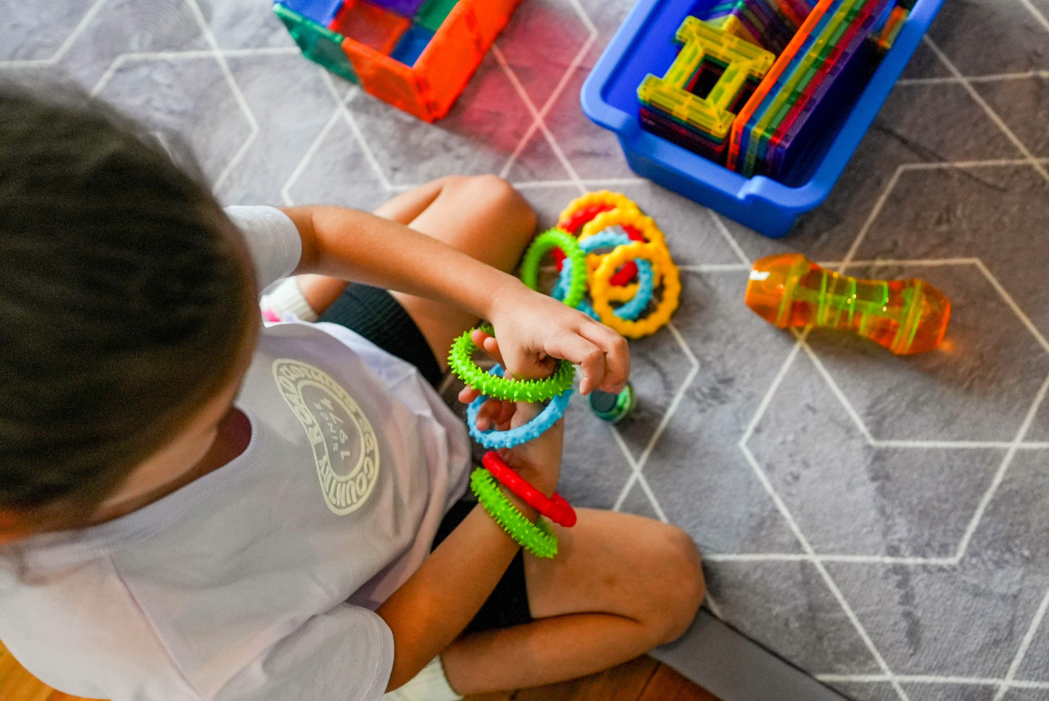 child playing with colourful bangles
