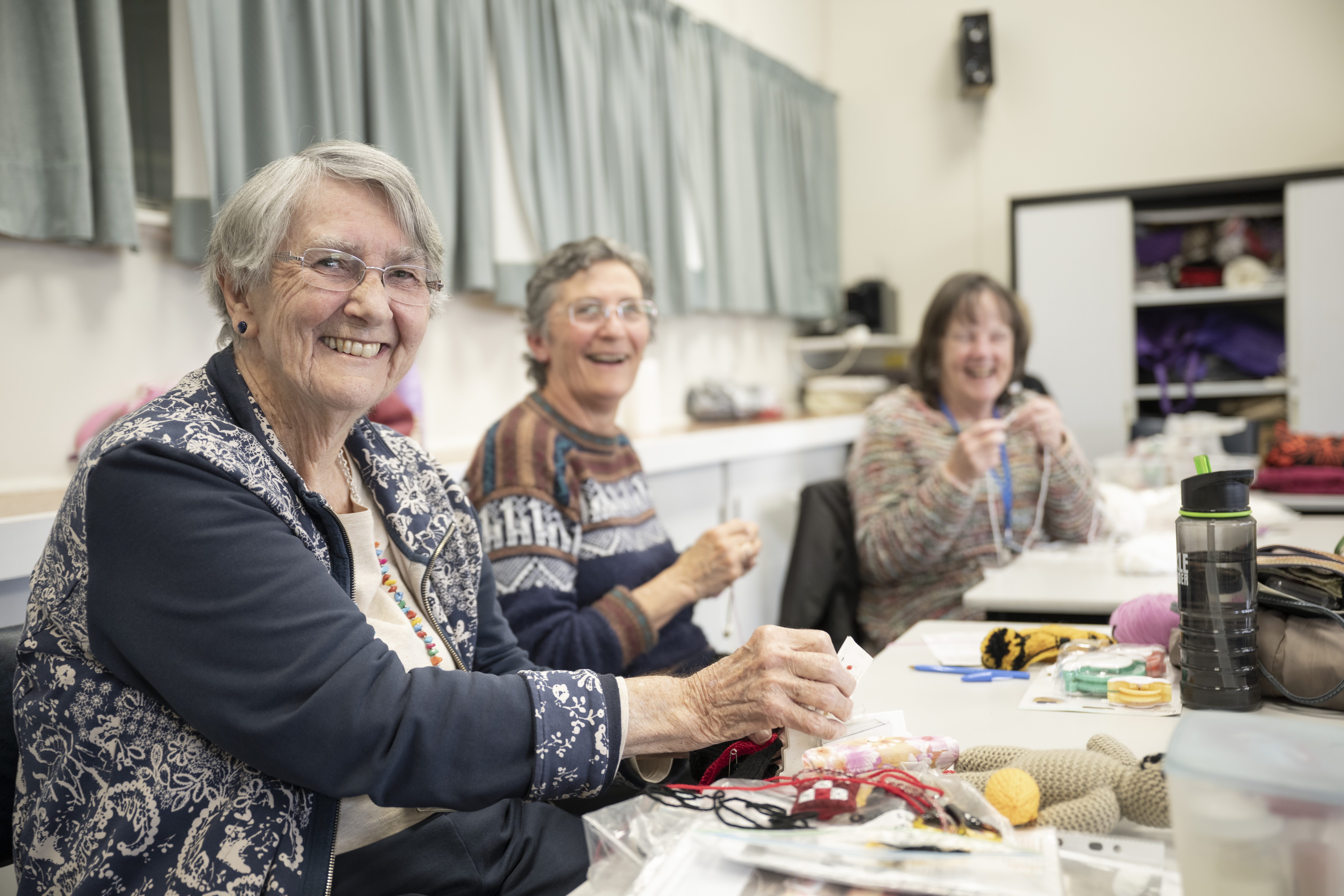 Older adults take part in a craft and learning activity together at a U3A Open Day.