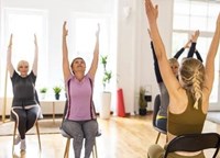 Seniors doing Chair Yoga with an instructor