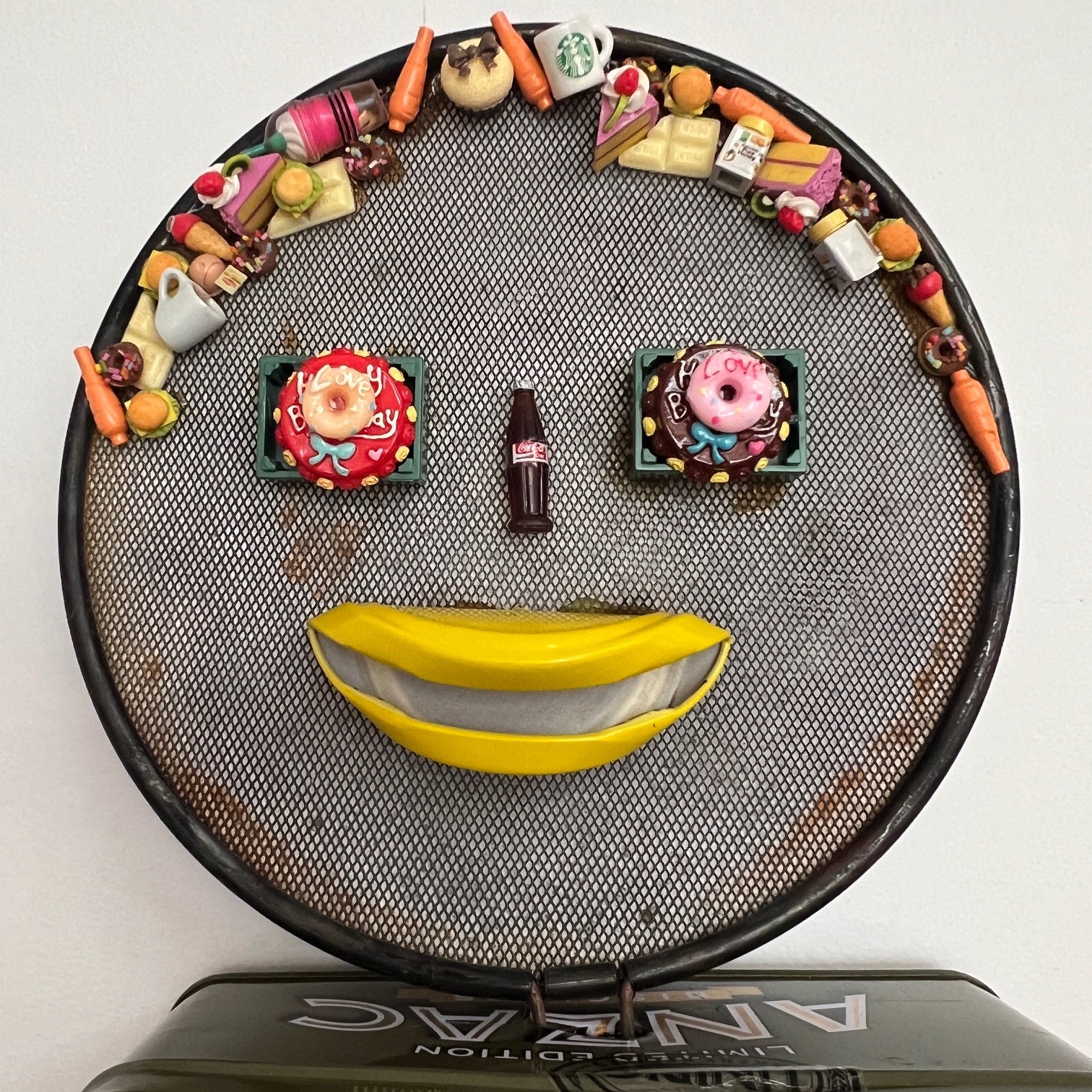 Pamela Irving | Jean, the Gourmand (detail) | 2024 Doll parts, plastic food, Anzac biscuit tin, simmer pan, electrical wire. 78 x 32cm | Courtesy of the artist