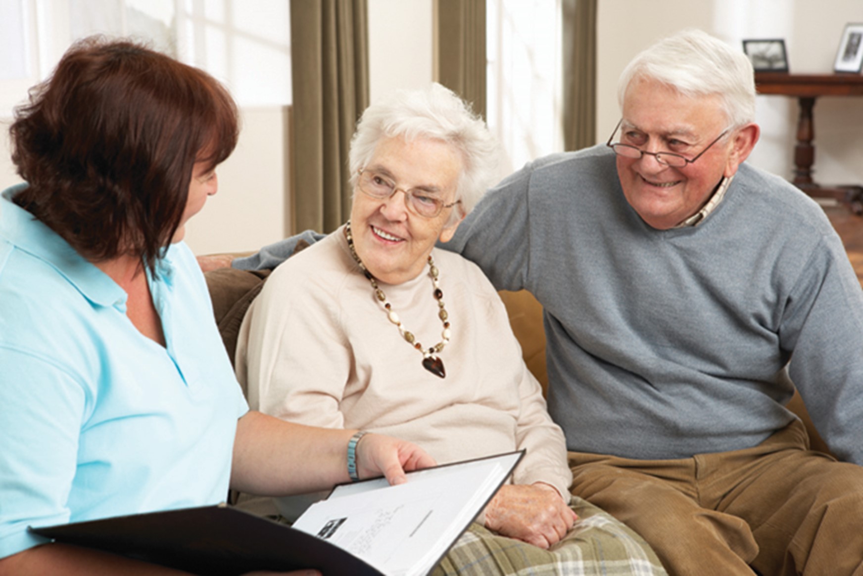 Women speaking with an elderly man and women
