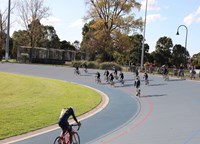 cyclists on a track around a park oval